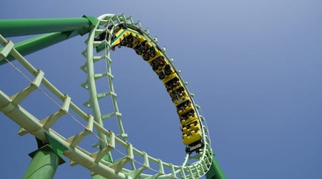 spiral loop of a green steel roller coaster